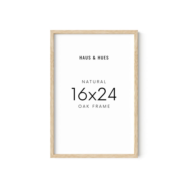 May include: A rectangular natural oak frame with the text "HAUS & HUES", "NATURAL", and "16x24 OAK FRAME" in black. The frame dimensions are 16 x 24 inches.
