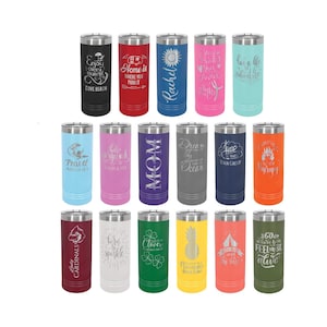 May include: A collection of 18 stainless steel tumblers with various colors and engraved designs. The designs include text, such as "Home is where you park it", "Travel Airlines", "Mom", "Dream in the Ocean", and "Go where you feel most alive".