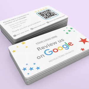 May include: Stacks of white business cards with the text "Review us on Google" in blue, red, yellow, and green. The cards also include a QR code and instructions for leaving a review. Colorful star graphics decorate the cards.