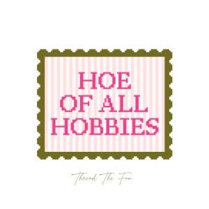 May include: A square design with the text "HOE OF ALL HOBBIES" in pink pixelated letters, set against a pink and white striped background. The design is framed by a green border with a postage stamp edge. The words "Thread The Fun" are written in a cursive font below the design.