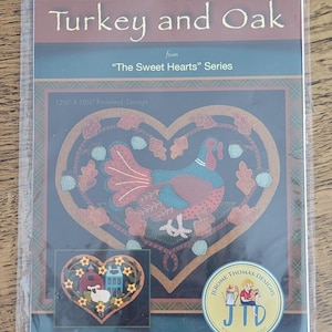 May include: A rustic wooden sign with the text "Welcome" in a handwritten style. The sign is painted white with a distressed finish, and features a decorative floral element in the corner. The background is a blurred image of a wooden surface.