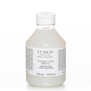 May include: A white bottle of Fusion Mineral Paint Tough Coat Matte Wipe-On Poly Non Yellowing. The bottle is 16.9 fl oz and contains a clear, white liquid. The bottle has a white cap and a white label with black text.