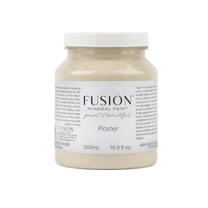 May include: A jar of Fusion Mineral Paint in the color "Plaster." The off-white paint is in a clear glass jar with a white lid. The label includes the text "paint it beautiful" and the volume is 16.9 fl oz.