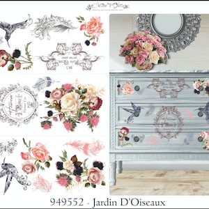 May include: A decorative transfer sheet with a floral design featuring pink, white and cream roses, black and grey feathers, and hummingbirds. The sheet also includes a decorative frame with the text "Heureux Reine Flower Co.". The sheet is 94.5 cm by 60 cm.