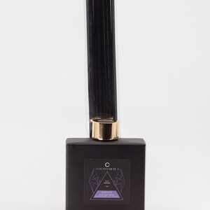 May include: Black glass reed diffuser bottle with a gold lid and black reeds. The label reads "Our Scent America" and "Reed Diffuser" with the scent name "Hypnos" and a description of the scent notes.