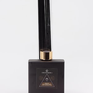 May include: Black diffuser bottle with a gold lid and black reeds. The label reads "Ourchemica" and "Thoth" with a geometric design. The scent is "Rose Empress".
