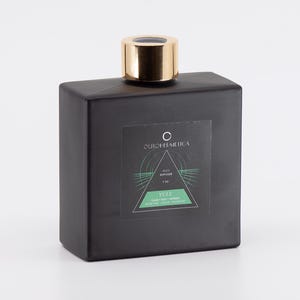 May include: A black glass bottle with a gold lid and a label that says "OURCOSMETICA" and "VULF" with a green and white graphic design.