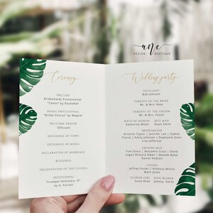 May include: A wedding ceremony program with a tropical theme. The program features a green and white tropical leaf design and lists the order of events for the ceremony. The text includes the names of the officiant, the bridal party, and the musicians.