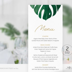 May include: A green watercolour leaf design with a white background. The text "Menu" is written in gold script. The menu includes a starter, main course, and dessert. The starter is Organic Mixed Baby Green Hearts of Palm, Candied Pecans with Golden Balsamic Vinaigrette. The main course is Grilled Prime Filet of Beef with Truffle Potato Gratin, Topped with Harical Vert Cognac Peppercorn Sauce or Salmon, Roasted and Seasoned with Bread Crumbs, Garlic, Lemon, and Butter Served with Bouquet of Fresh Seasonal Vegetables and Golden Fried Potato Croquette. The dessert is Vanilla White Chocolate Wedding Cake with Fresh Berries and Vanilla-Champagne Sauce. The text "2 Sizes Included" is in a black box with a white border. The text "ANE DESIGN BOUTIQUE on Etsy" is at the bottom left corner of the image. The text "ane DESIGN BOUTIQUE" is at the bottom right corner of the image.