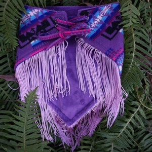 May include: Purple and pink fringed scarf with a geometric pattern and a lace-up detail.