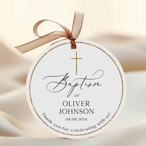 May include: A circular baptism tag with a gold glitter border and a brown ribbon. The tag displays a cross, the word "Baptism", the name "OLIVER JOHNSON", and the date "08.08.2026". The text "Thank you for celebrating with us!" is also included.