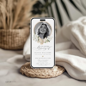 May include: A smartphone displaying a memorial invitation. The invitation features a black and white photo of a woman within a gold frame, surrounded by white flowers and a dove. The text reads "In Loving Memory of Olivia Williams".