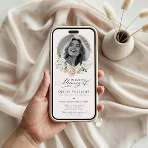 May include: A smartphone displays a memorial announcement. The design features a photo of a woman, floral accents, and the text "In Loving Memory of Olivia Williams." The announcement includes dates, times, and locations for the service and reception.