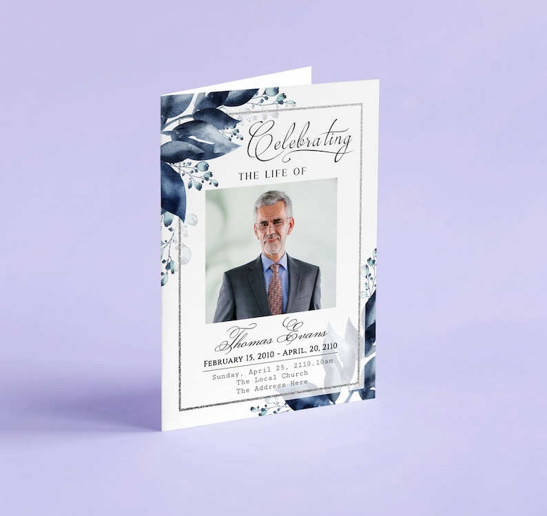 May include: A white memorial card with a blue watercolour floral design. The card features a photo of a man in a suit and tie. The text reads "Celebrating the Life of Thomas Evans, February 15, 2010 - April 20, 2110. Sunday, April 25, 2110, 10am, The Local Church, The Address Here."