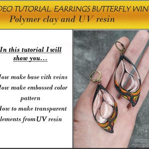 May include: A pair of butterfly wing earrings made with polymer clay and UV resin. The earrings are a teardrop shape with a clear, translucent center and black and orange details. The earrings are shown on a hand.