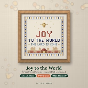 May include: A cross stitch pattern in a wooden frame featuring the text JOY TO THE WORLD THE LORD IS COME in red and blue, a gold star, and a tan cityscape. Below the frame, text reads Joy to the World, Cross Stitch Pattern, 131 x 131 stitches.