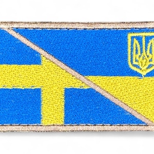 May include: Embroidered patch featuring a combination of the Ukrainian and Swedish flags. The design includes a blue and yellow color scheme, with a gold border. The Ukrainian coat of arms is in the upper right corner.