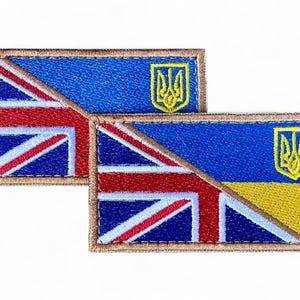 Peut inclure: Deux écussons brodés combinant les drapeaux du Royaume-Uni et de l'Ukraine. Les écussons rectangulaires ont une bordure marron. La partie britannique présente des rayures rouges et blanches sur fond bleu. La partie ukrainienne est bleue et jaune, avec un emblème doré.