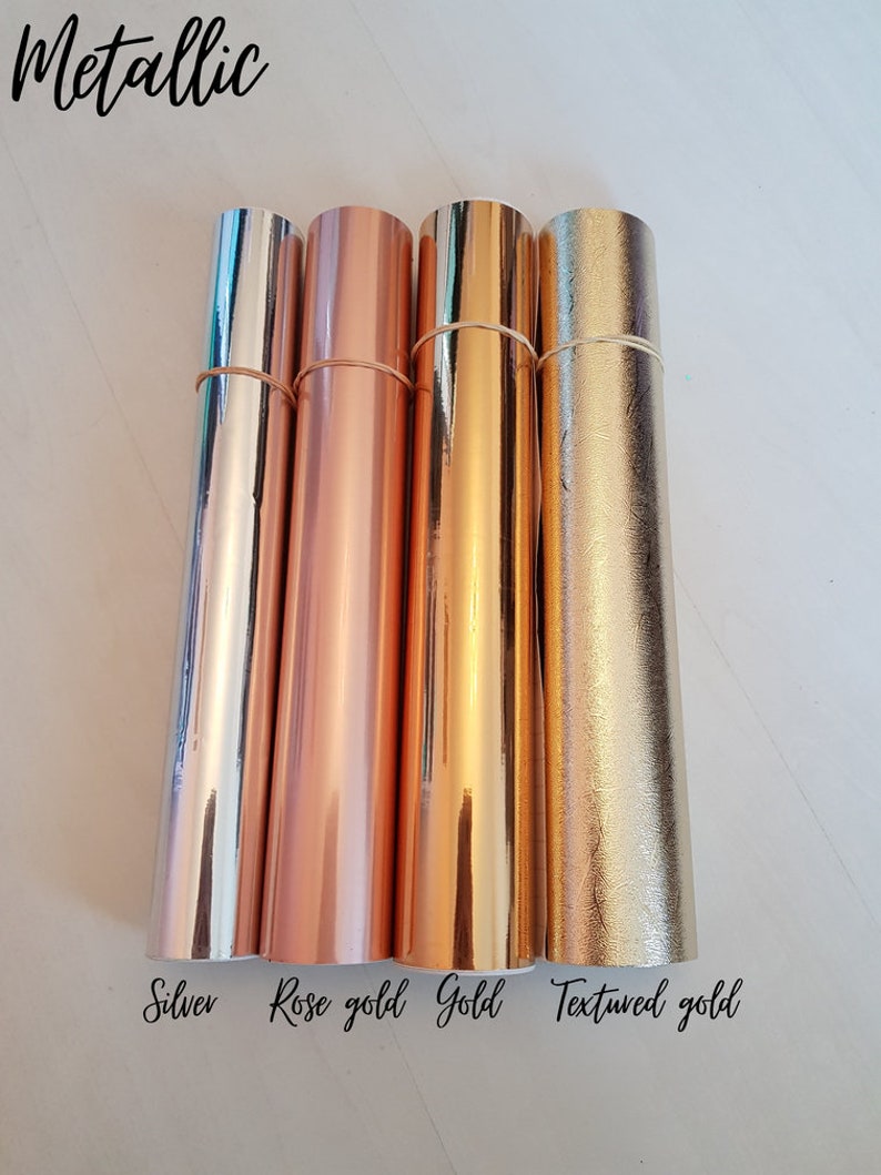 May include: Four rolls of metallic vinyl in silver, rose gold, gold, and textured gold. The rolls are labeled with the color names.