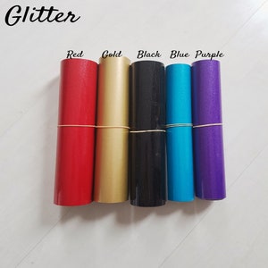 May include: Five rolls of glitter adhesive vinyl in red, gold, black, blue, and purple. The rolls are labeled with the color name.
