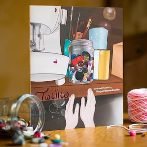 May include: A book titled Twillie by Morgan Blankenbeckler featuring an illustration of a sewing machine, a jar filled with colorful buttons, paintbrushes, and two hands. The cover art includes a dark lower section with bubbles and a light upper section.