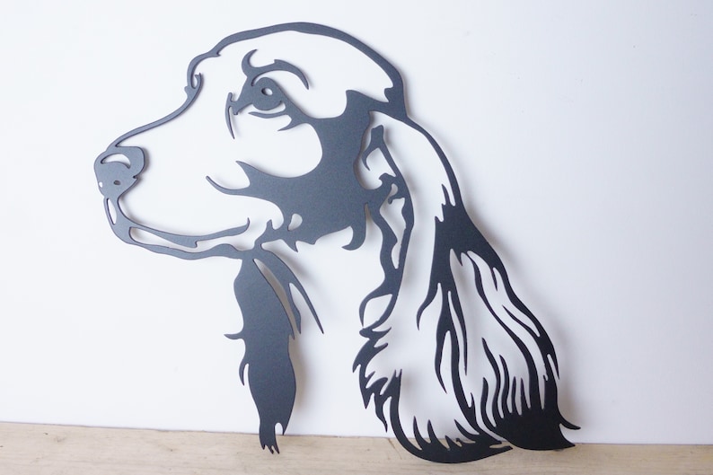 Black silhouette, metal cocker spaniel wall art showing profile head and long flowing ear, smooth edges on white wall