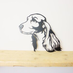 Metal cocker spaniel wall art displayed on wooden bench for scale, 2.5mm mild steel silhouette, indoor or garden decor