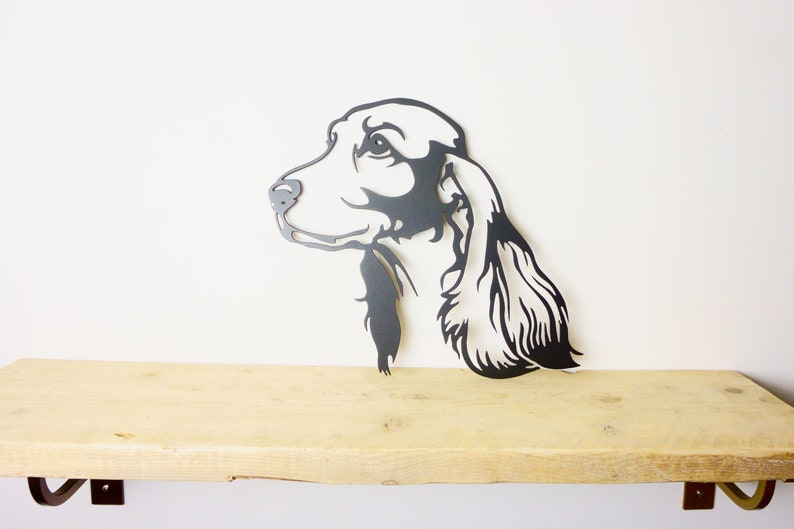 Metal cocker spaniel wall art displayed on wooden bench for scale, 2.5mm mild steel silhouette, indoor or garden decor