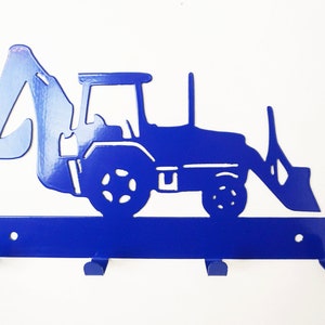May include: Blue metal key holder shaped like a construction excavator with three hooks.
