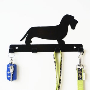 Front view black powder-coated mild steel wire haired dachshund leash holder, three leads hanging