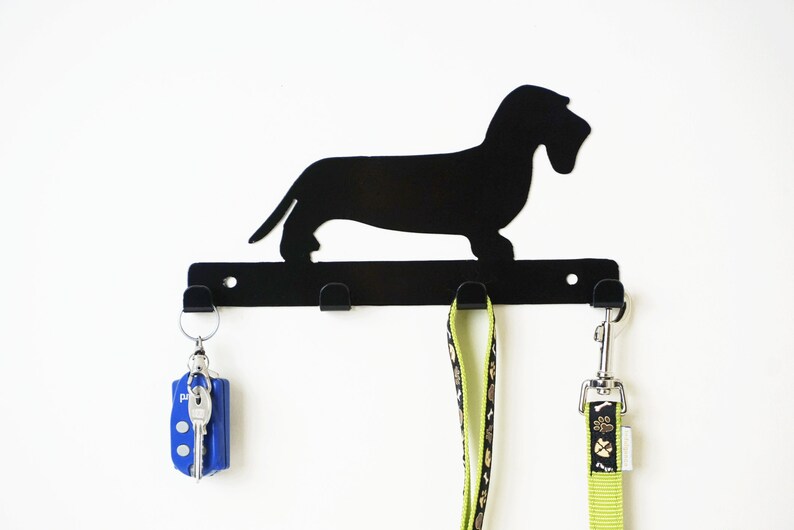 Front view black powder-coated mild steel wire haired dachshund leash holder, three leads hanging