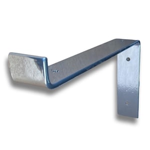 Close-up of a chrome scaffold board shelf bracket corner, welded right-angle, visible screw holes, steel finish