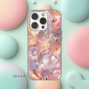 May include: Clear phone case with a colorful, abstract design featuring pink, orange, and clear bubble-like shapes. The case has a silver camera cutout and the word "SNUKIN" is printed on the bottom left.