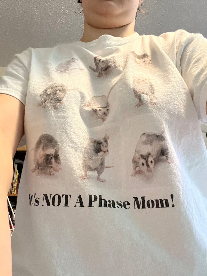 Pode incluir: Camiseta branca com um gr&aacute;fico de v&aacute;rios ratos e o texto "It's NOT A Phase Mom!"