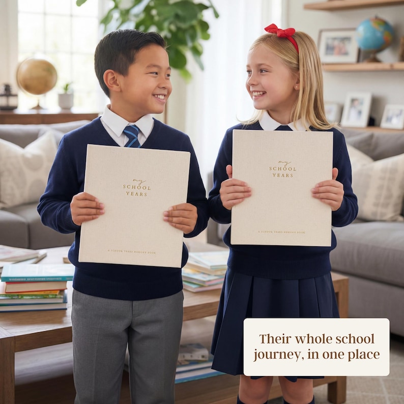 May include: Two children in school uniforms hold beige notebooks labeled "my SCHOOL YEARS." The notebooks have a simple design with gold lettering. The children are smiling, suggesting a positive experience with the notebooks.
