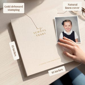 May include: A natural linen cover memory book with gold debossed stamping that reads "my SCHOOL YEARS". The book is 12 x 10 inches. A photo of a young girl is next to the book.