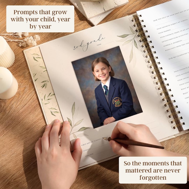 May include: A spiral-bound memory book with a photo of a child in a school uniform. The book is open, with text that reads "Prompts that grow with your child, year by year" and "So the moments that mattered are never forgotten."
