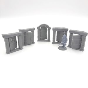 May include: Five miniature gray wooden doors with different styles and designs. The doors are made of a textured material and have a realistic look.