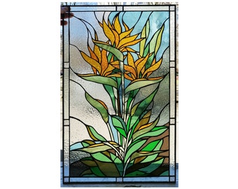May include: A stained glass window panel featuring a vibrant floral design. The panel depicts a cluster of orange and yellow bird of paradise flowers with green leaves against a blue and white background.