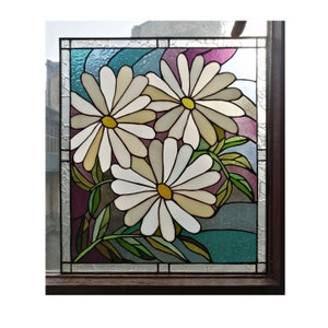 May include: A stained glass window panel featuring three white daisies with yellow centers, set against a background of purple, blue, and green.