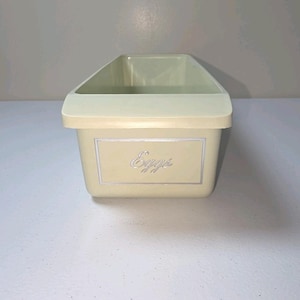 May include: A white ceramic mug with a black handle and the text "But first, coffee" in a black, handwritten-style font. The mug is on a white surface.