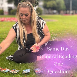 May include: A woman with long blonde hair sits on the grass, holding a deck of cards. Several tarot cards are laid out in front of her. Text on the image reads "Same Day General Reading One Question."