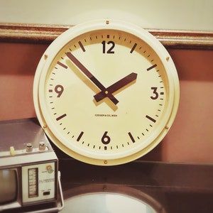 May include: A white round clock with black hands and black numbers. The clock face has the text "CZEIGER & CO. WIEN".