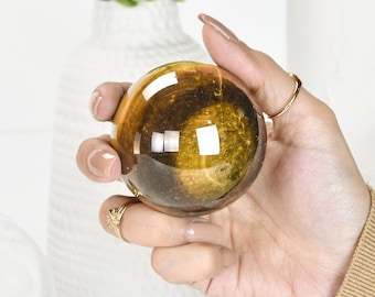 Gleaming Yellow Tiger Eye Crystal Ball: A Stunning Sphere of Power and Protection