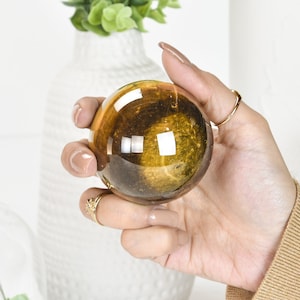 Gleaming Yellow Tiger Eye Crystal Ball: A Stunning Sphere of Power and Protection image 1