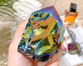 May include: A large iridescent crystal with a rough, textured surface. The crystal is a deep blue, green, and purple color with a metallic sheen.