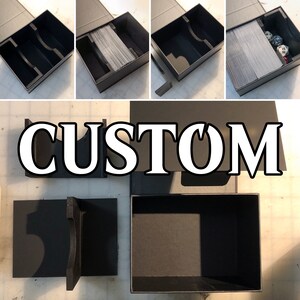 May include: A black box with a custom insert for holding cards and dice. The box is open and the insert is visible. The insert has a slot for cards and a compartment for dice. The box is labeled "CUSTOM".
