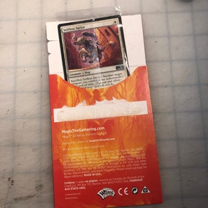 May include: A Magic: The Gathering trading card featuring a brown and white dog creature with a blue and white background. The card is titled "Selfless Savior" and has the text "Sacrifice Selfless Savior: Another target creature you control gains indestructible until end of turn. (Damage and effects that destroy don't destroy it.)"