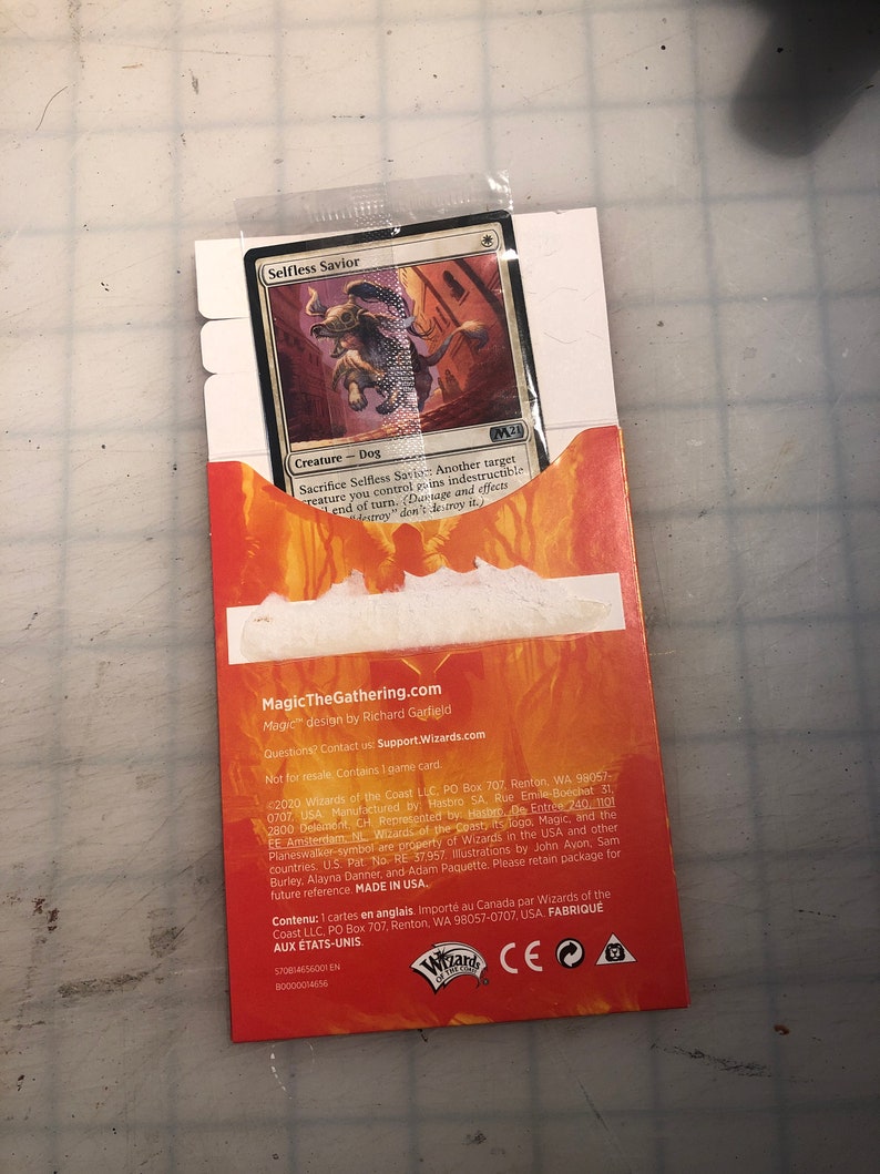 May include: A Magic: The Gathering trading card featuring a brown and white dog creature with a blue and white background. The card is titled "Selfless Savior" and has the text "Sacrifice Selfless Savior: Another target creature you control gains indestructible until end of turn. (Damage and effects that destroy don't destroy it.)"