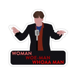 May include: A sticker featuring a cartoon illustration of a person holding a microphone and a cigarette. The person is wearing a black suit, a red scarf, and a blue shirt. The text "WOMAN WOE-MAN WHOAA MAN" is printed in red and white on a black background.